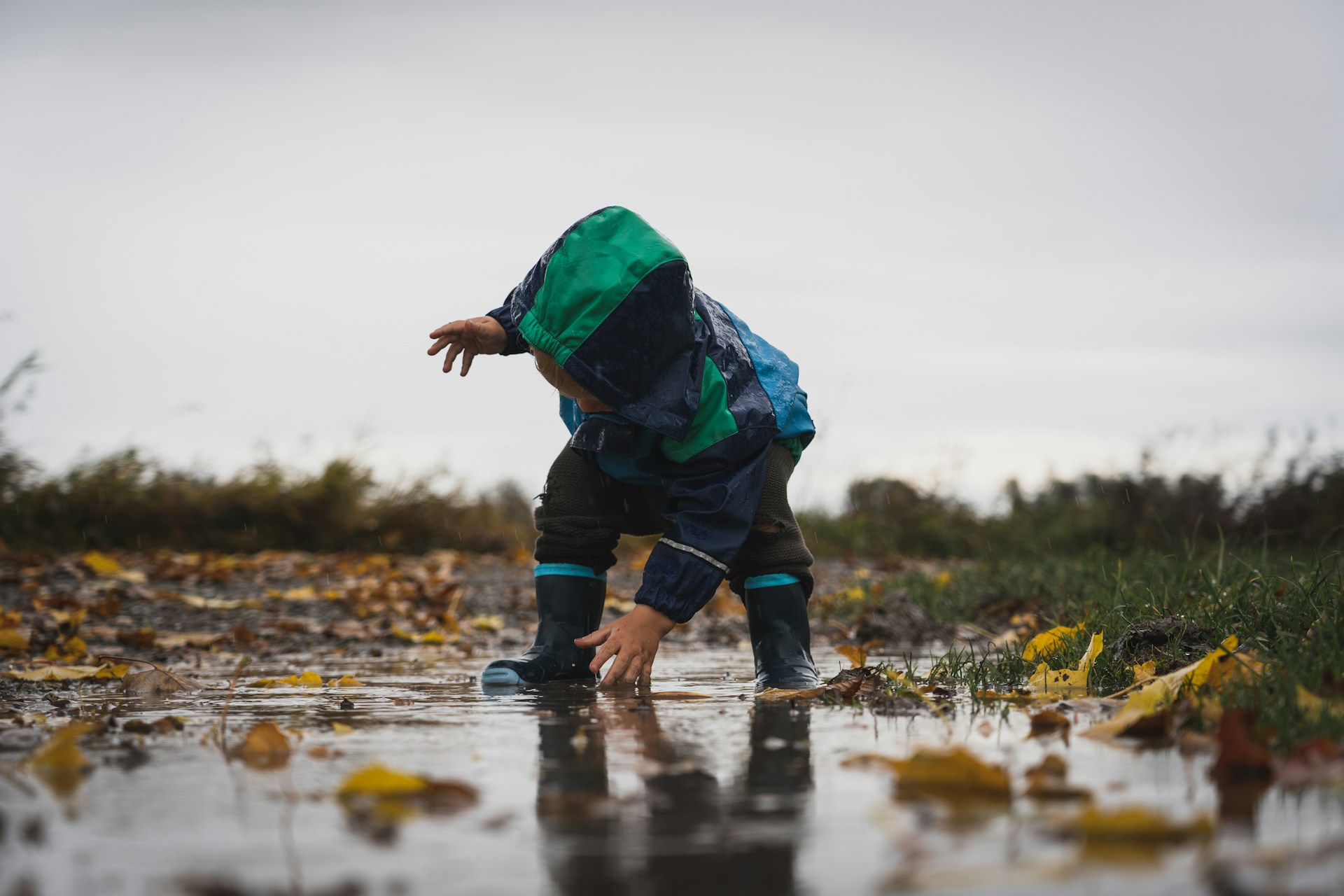 A child playing in a puddle